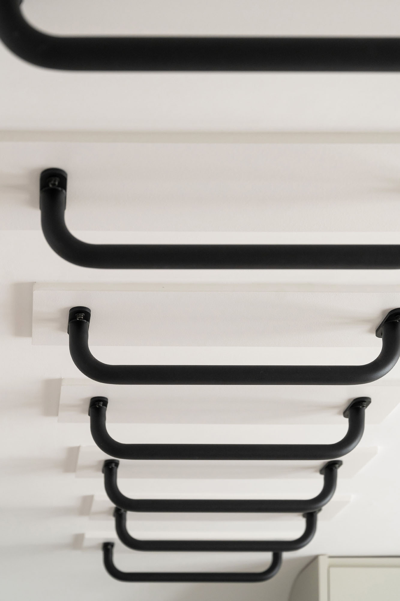 Funky Little Darlings added monkey bars climbing up the wall and across the ceiling in a custom boys' bedroom in Amersham near Beaconsfield, designed for active play and movement.