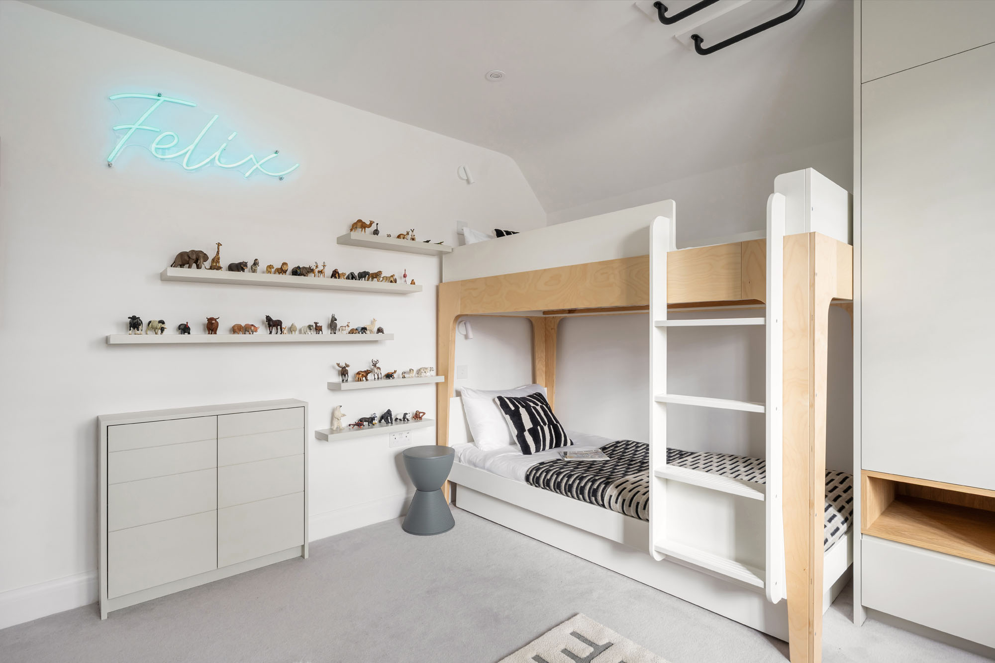 Funky Little Darlings Amersham boys bedroom with bunk bed neon sign and schleich animal display shelves and cupboard with hidden secret tunnel to siblings bedroom.