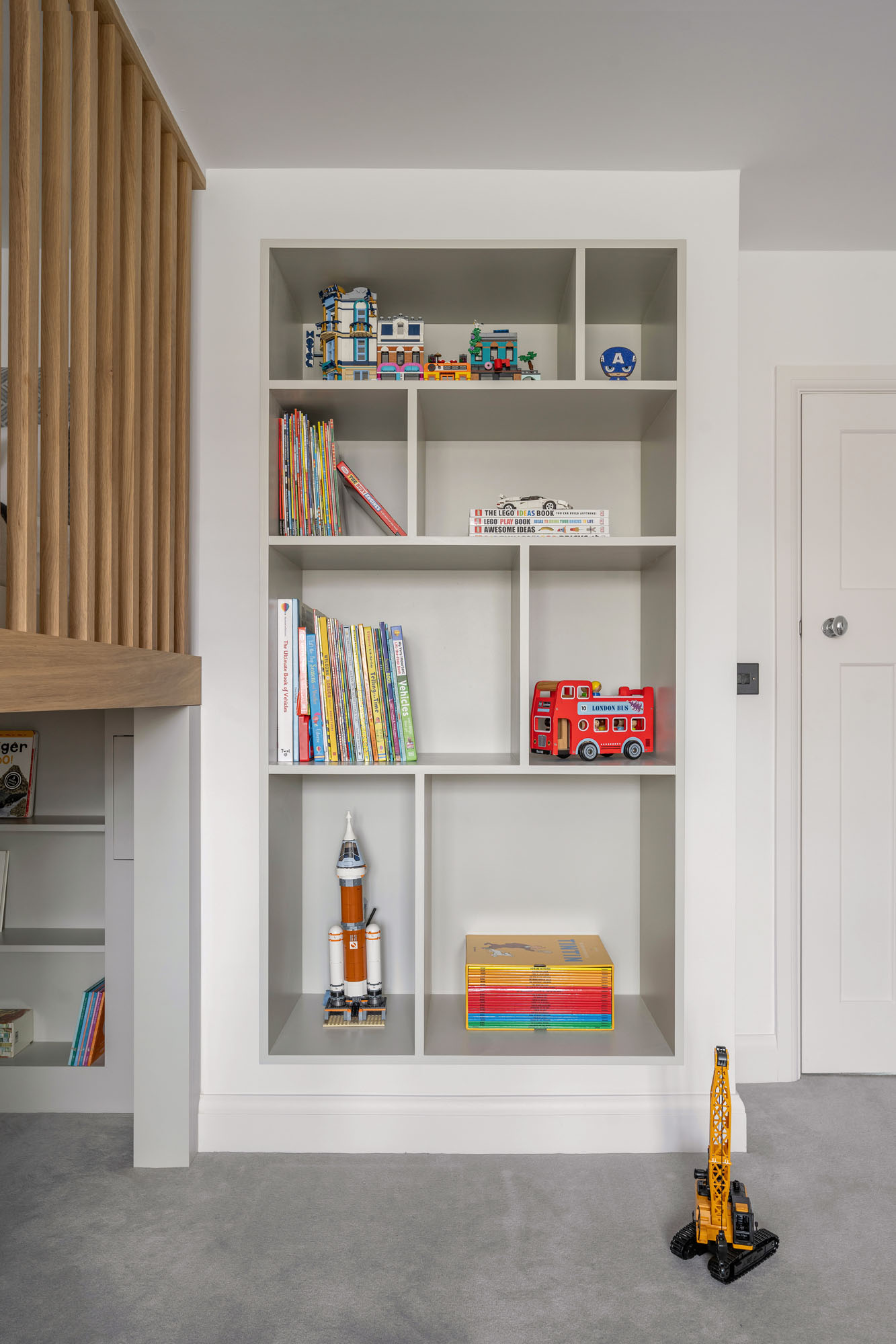 Funky Little Darlings Amersham boy's bedroom featuring stylish wall-mounted bookcase storage creating a modern, space-saving design for kids room organisation.