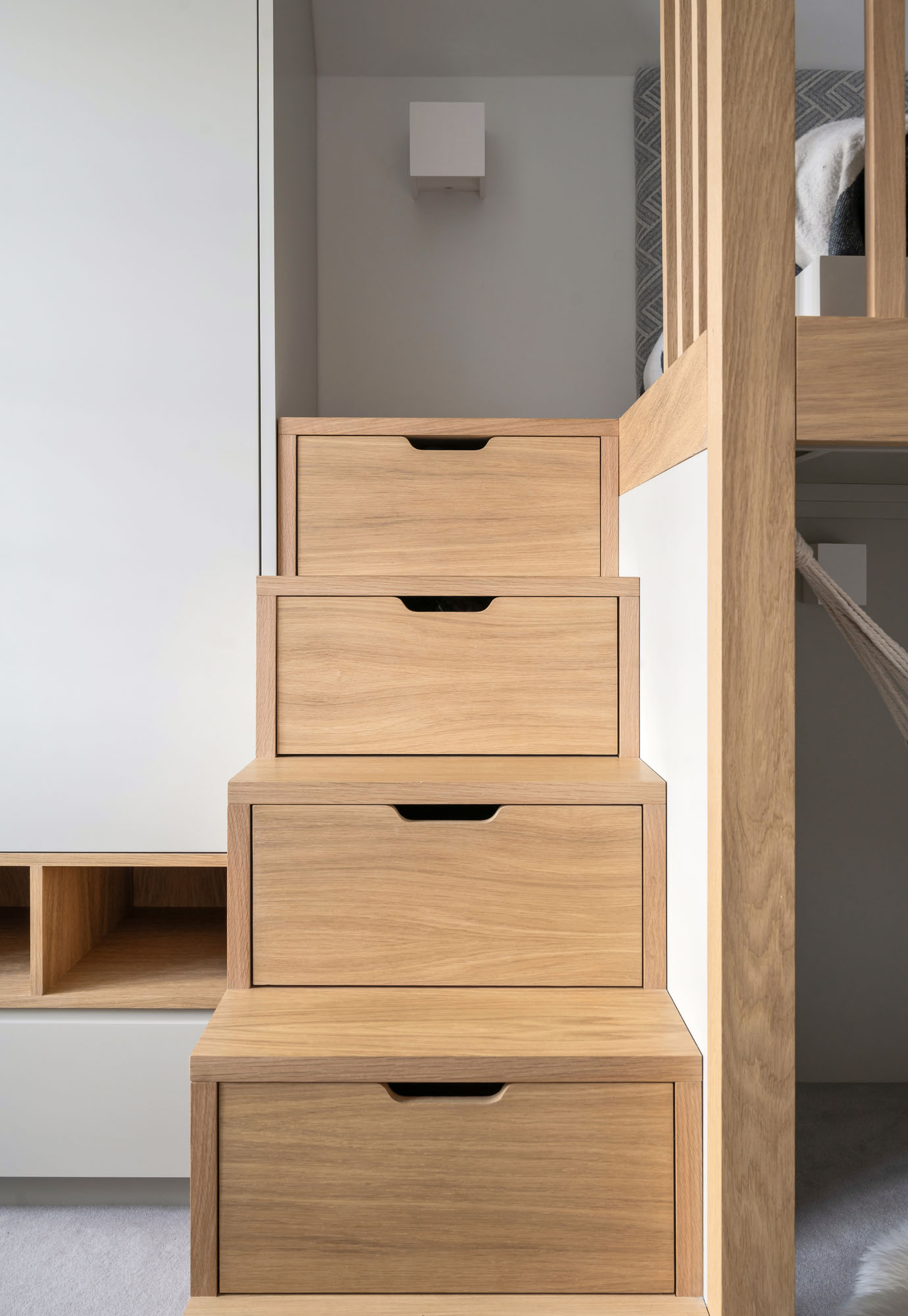 Funky Little Darlings boys bedroom in Amersham featuring oak storage drawers built into loft bed steps, combining playful design with functional storage.