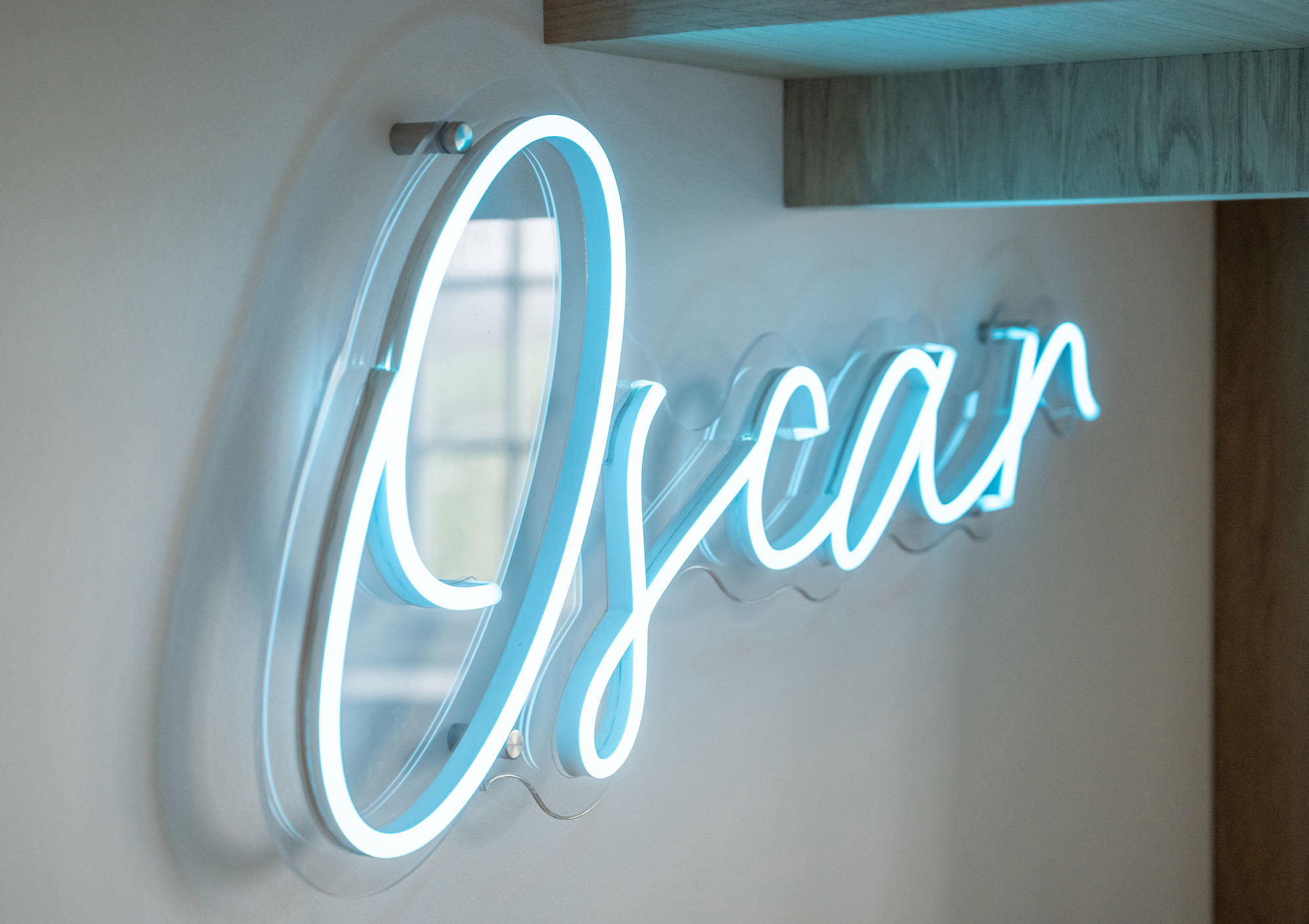 Custom neon name sign in a boy’s bedroom designed by Funky Little Darlings in Amersham creates playful personalised wall decor for modern interior styling.