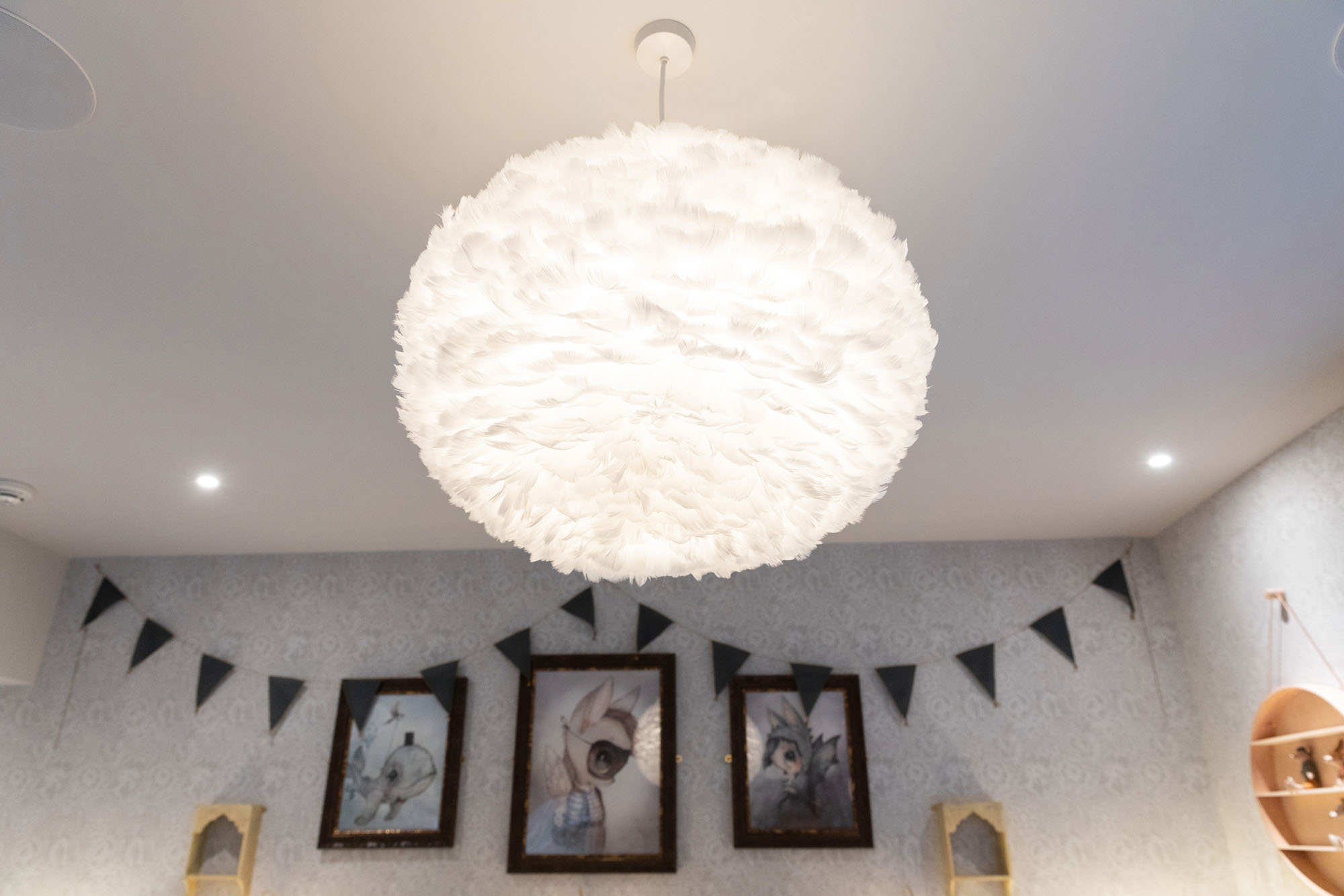 Stylish shared triple children's bedroom in Cobham designed by Funky Little Darlings, featuring a soft Eos feather pendant light creates a whimsical, cosy atmosphere perfect for a children's bedrooms.