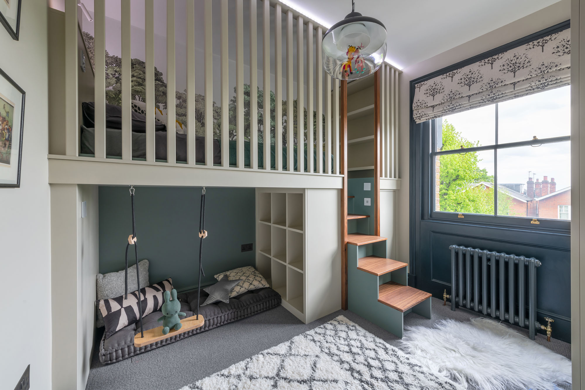 Cool Hampstead boy’s bedroom by Funky Little Darlings, featuring a raised cabin bed with built-in storage steps, a cosy reading nook play space under the bed with playful swing, creating a functional and fun space for kids.