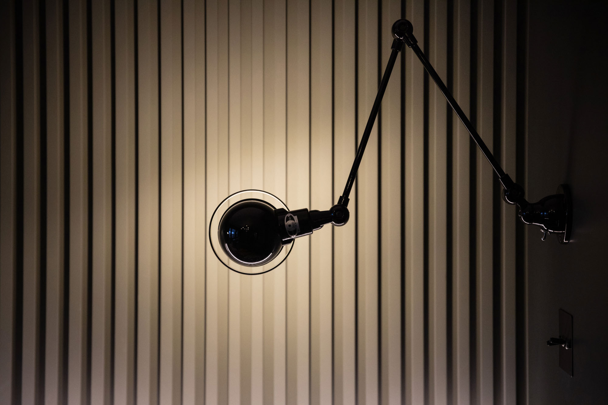 Modern Hampstead boy’s bedroom designed by Funky Little Darlings featuring Little Green Scree grey painted slatted wall panelling and industrial-style black Jielde Signal wall lights, combining modern textures and stylish lighting in a high-end design-led children’s room interior.