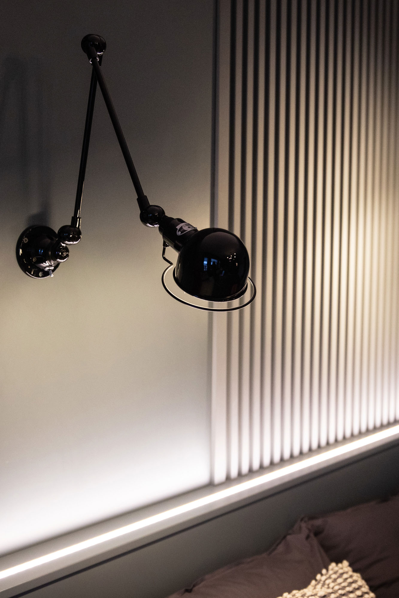 Modern Hampstead boy’s bedroom designed by Funky Little Darlings featuring Little Green Scree grey painted slatted wall panelling, LED uplighter on bed headboard and industrial-style black Jielde Signal wall lights, combining modern textures and stylish lighting in a high-end design-led children’s room interior.