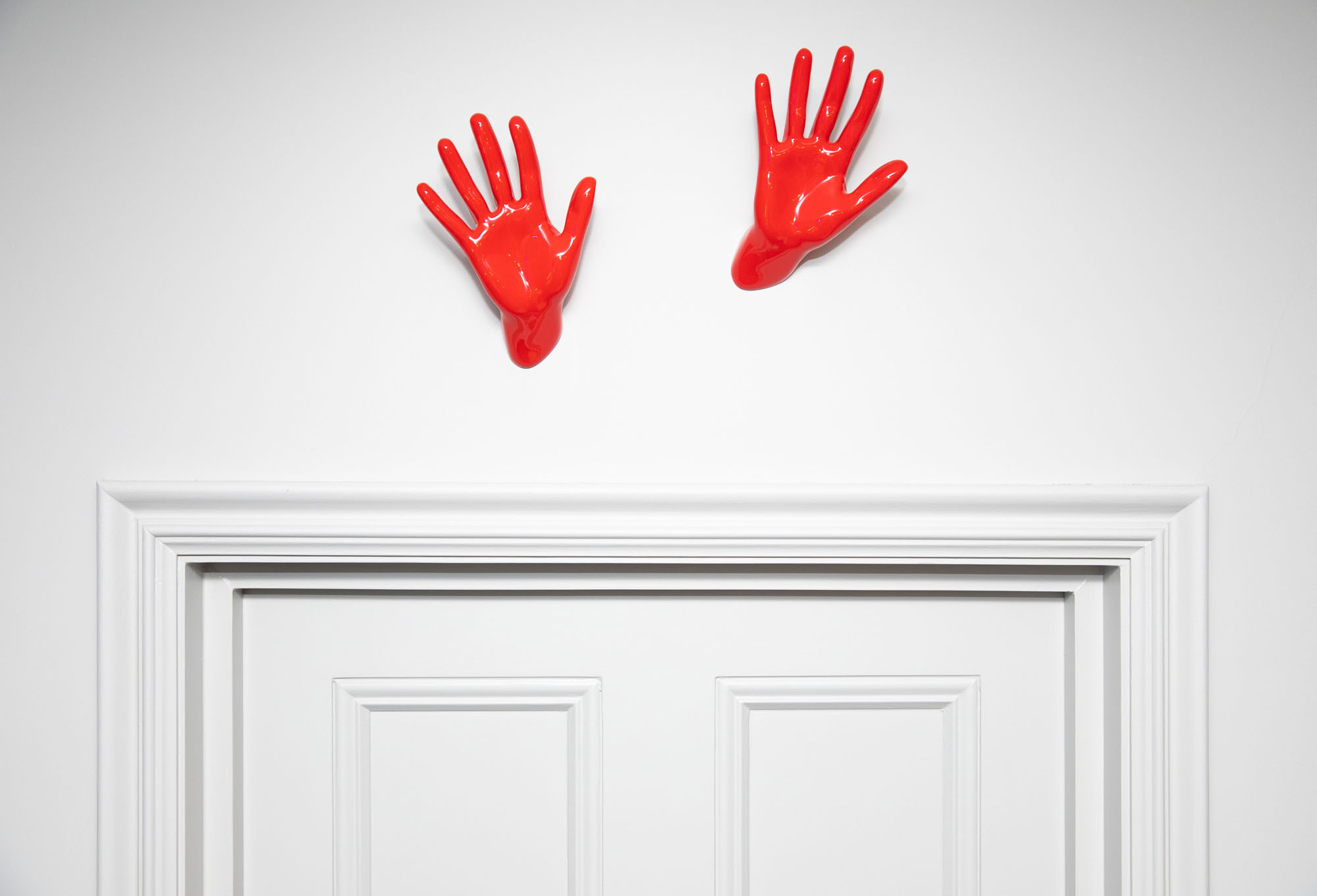 Funky Little Darlings Hampstead boys bedroom showcasing a playful and vibrant design with bold red Handjob Wave wall hooks mounted high on the wall above the door, featuring modern kids' room decor elements, perfect for a fun and functional children’s space.