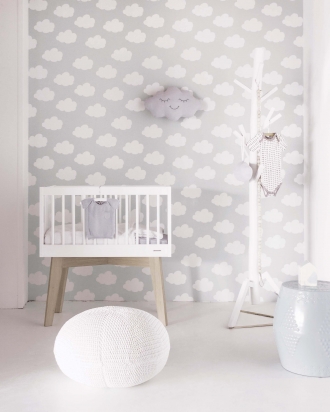 White cot with cloud wallpaper