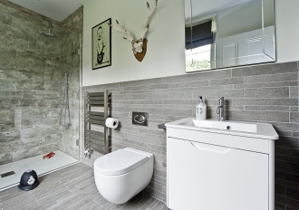 Grey boys bathroom with Banksy picture